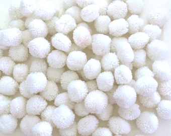 May include: A large pile of white fluffy pom poms. The pom poms are soft and round, and they are perfect for crafting projects.