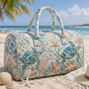May include: Quilted duffel bag with a beach theme. The bag features a pattern of sea turtles, starfish, and coral in shades of blue, green, and pink. The text "Ride the Wave" is visible on the side. The bag has two handles and a zipper closure.