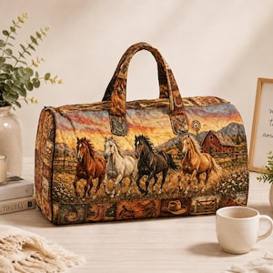 May include: A quilted duffel bag featuring a printed scene of four horses running through a field with a red barn and windmill in the background. The fabric pattern includes smaller images of cowboy boots, hats, and horseshoes along the bottom edge.
