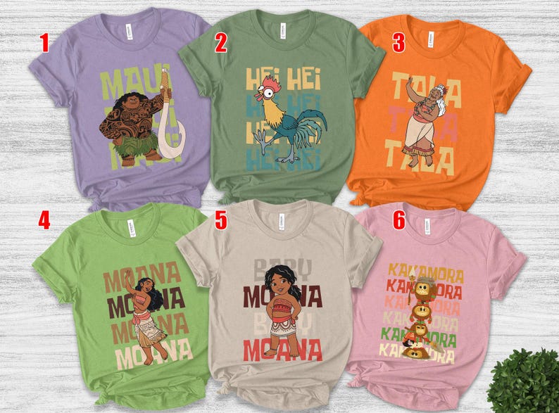 May include: Six short-sleeved t-shirts featuring characters and text from the animated film Moana. The shirts are in various colors, including purple, green, orange, and pink. Each shirt has a different design, with characters like Maui, Hei Hei, and Moana.