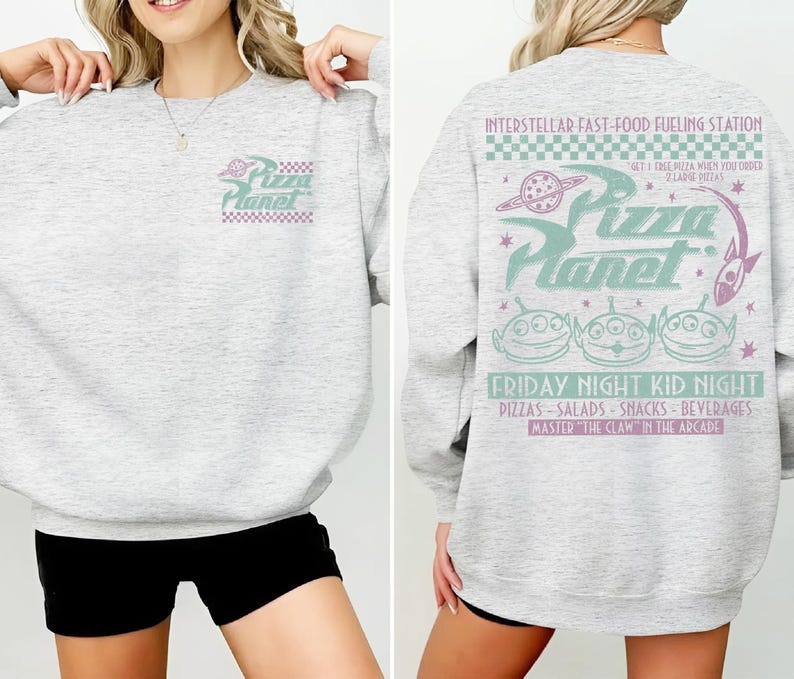May include: Light gray sweatshirt with "Pizza Planet" logo on the front and back. The back features the text "Interstellar Fast-Food Fueling Station" and "Friday Night Kid Night" with alien graphics and other text.