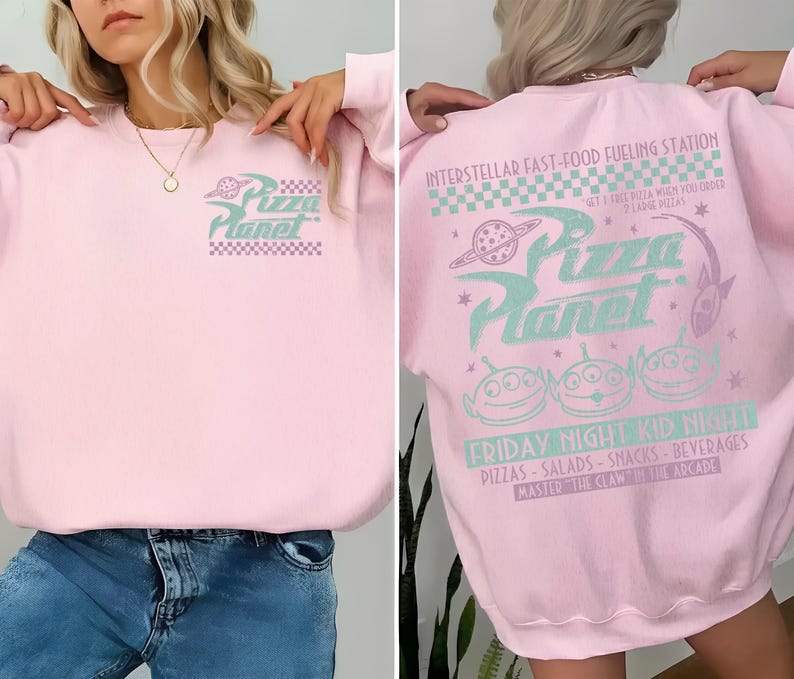May include: A light pink sweatshirt with the Pizza Planet logo on the front and back. The front features the logo in a teal and purple color scheme. The back has the text "INTERSTELLAR FAST-FOOD FUELING STATION" and "FRIDAY NIGHT KID NIGHT".