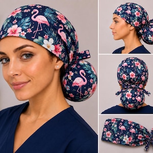 May include: A navy blue scrub cap featuring a vibrant tropical pattern of pink flamingos, white and pink hibiscus flowers, and green palm leaves. The cap includes a rounded back pouch for hair and a tie closure to secure the fit around the head.