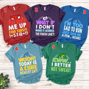 May include: Five colorful t-shirts with Inside Out character graphics and humorous phrases. The shirts are red, purple, blue, teal, and green. Each shirt has a unique design with bold, white text.