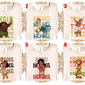 May include: Six white t-shirts with colorful graphics and text from the animated movie Moana. The designs include characters like Maui, Hei Hei, and Moana, along with text like "Maui", "Hei Hei", "Tala", "Moana", and "Kakamora".