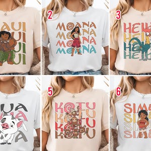 May include: Collection of six t-shirts featuring characters and text from the animated movie. Each shirt has a different design, including characters like Maui, Moana, Hei Hei, Pua, Koku, and Sima, with their names in bold, colorful fonts.