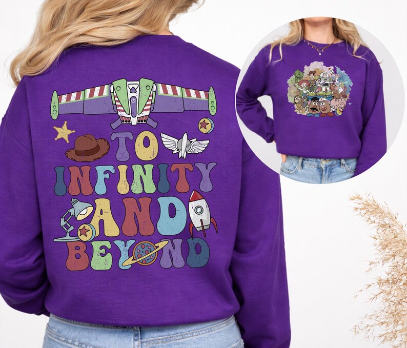 May include: A purple sweatshirt featuring a colorful graphic design from the movie Toy Story. The back of the sweatshirt has a Buzz Lightyear spaceship design, the phrase "To Infinity and Beyond", and other character illustrations. The front has a group of Toy Story characters.