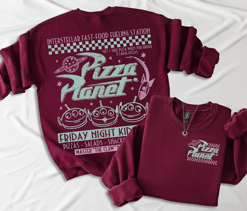 May include: Two maroon sweatshirts with the Pizza Planet logo and graphics. One sweatshirt has a large design on the back with the text "Interstellar Fast-Food Fueling Station" and "Friday Night Kid". The other has a small logo on the front.