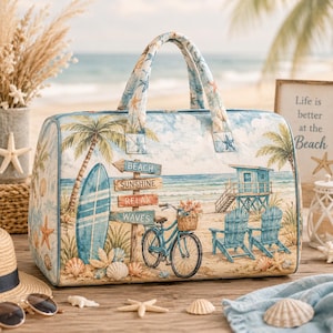 May include: A rectangular travel bag featuring a beach-themed print with palm trees, a surfboard, a blue bicycle with a basket, two wooden chairs, and a signpost reading Beach, Sunshine, Relax, Waves. The bag has two top handles and a zipper closure.