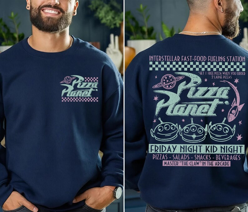 May include: Navy blue sweatshirt featuring the Pizza Planet logo on the front and back. The front logo is a stylized design with the words "Pizza Planet" and a checkered border. The back of the sweatshirt has the text "INTERSTELLAR FAST-FOOD FUELING STATION".