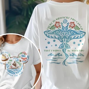 May include: White t-shirts with graphic designs. One shirt features a blue manta ray design with text, and the other has a Mickey Mouse head shape filled with tropical imagery and text. Both shirts have short sleeves.