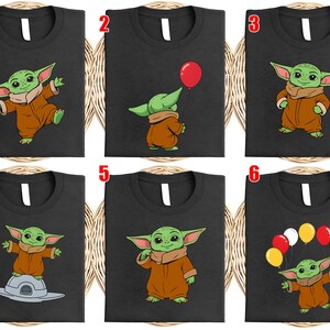 May include: Black t-shirts featuring a cartoon character in various poses. The character is green with large ears, wearing a brown coat. Some shirts show the character with a red balloon or holding colorful balloons.