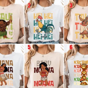 May include: A collection of six t-shirts featuring characters and text from the animated movie. The shirts display images of Maui, Hei Hei, Tala, Moana, Baby Moana, and the Kakamora. Each shirt has a unique design with vibrant colors and text.