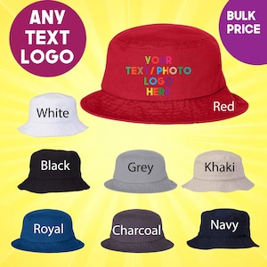 May include: A set of ten bucket hats in various colors, including white, red, black, grey, khaki, royal blue, navy blue, and charcoal. The hats are all made of a soft, comfortable fabric and feature a wide brim. The red hat has the text "YOUR TEXT/PHOTO LOGO HERE" printed on it in rainbow colors.