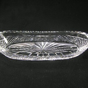 May include: A clear glass oval serving dish with a cut crystal design.