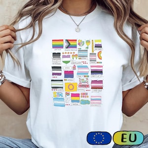 Könnte beinhalten: Weißes T-Shirt mit einer bunten Grafik verschiedener LGBTQ+-Pride-Flaggen, einschließlich der Progress Pride-Flagge, und dem Text "LOST FLAG". Das Design umfasst Flaggen für Genderqueer, Asexuell, Trans und Intersex. Das T-Shirt hat einen Rundhalsausschnitt.