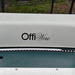 May include: A white OffiWire electric wire binding machine with a green base and a black ruler.