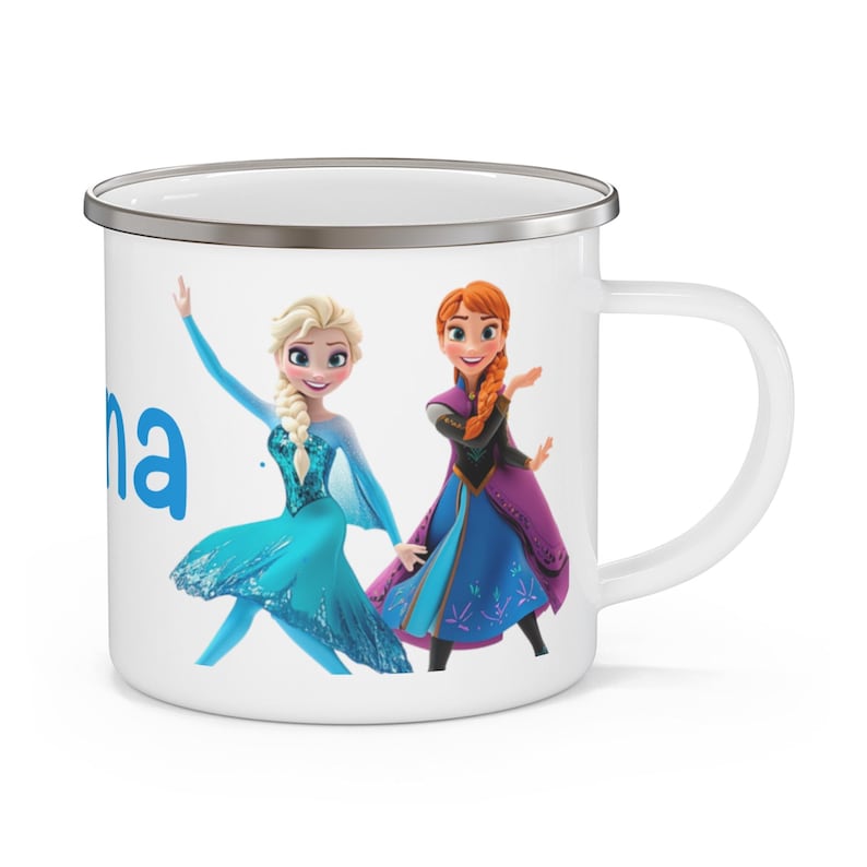 May include: White enamel mug featuring the characters Elsa and Anna from the movie Frozen. The mug has a silver rim and a white handle. The name "Anna" is printed in blue on the side of the mug.
