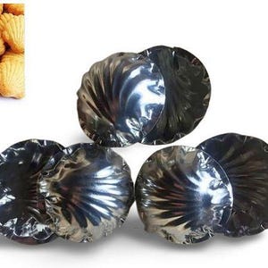 May include: Five silver metal molds shaped like seashells. The molds are arranged in a pyramid shape.