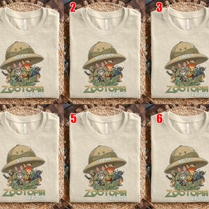 May include: Beige t-shirts with a Zootopia graphic featuring characters from the movie, a safari hat, and the text "ZOOTOPIA TRIP 2026". Each shirt has a different label on the hat: "MOMMY", "BROTHER", "DADDY", "LIL SIS", "SOPHIE", and "BIG SIS".
