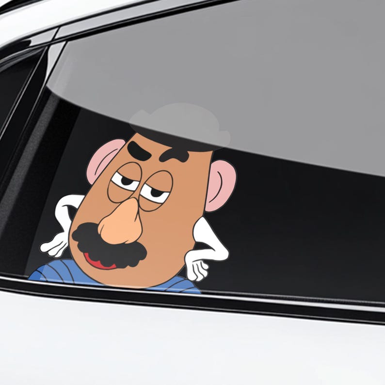 May include: A cartoon decal of a potato-shaped character with a large nose, mustache, and sleepy eyes. The decal is brown, with pink ears and a blue shirt. The character is leaning on a car window.
