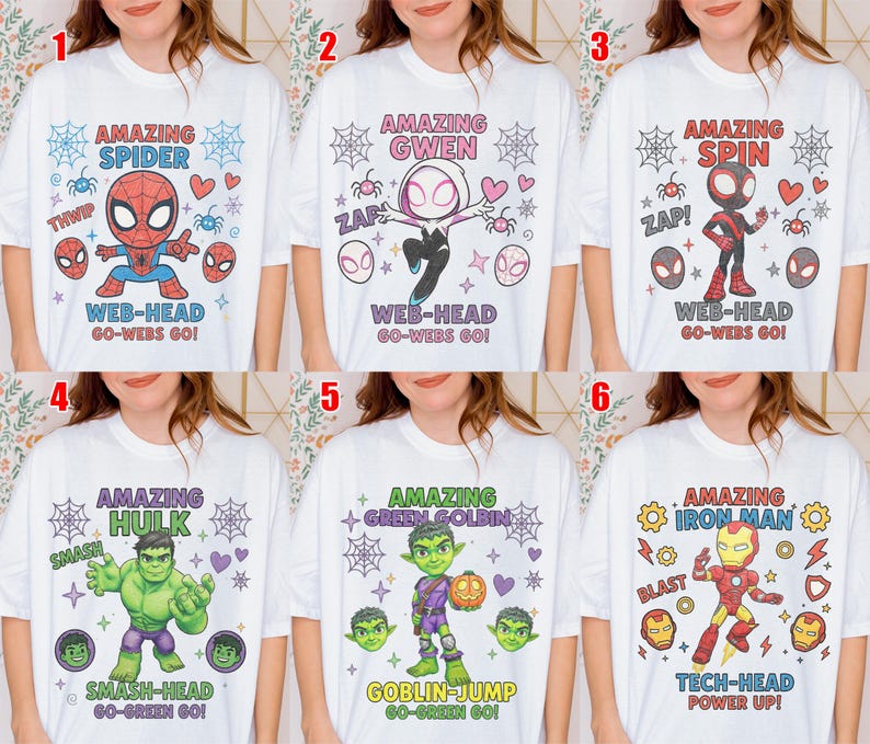 May include: A selection of white t-shirts, each adorned with a vibrant superhero design. The shirts showcase characters such as Spider-Man, Gwen, Spin, Hulk, Green Goblin, and Iron Man. Text includes character names and phrases.