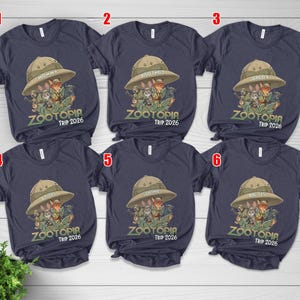 May include: Navy blue t-shirts with a Zootopia graphic featuring characters in safari hats. Each shirt has a different family member's name above the graphic and "Zootopia Trip 2026" below.