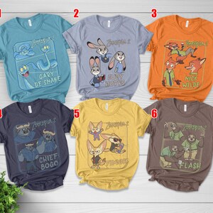 Pode incluir: Seis camisetas de manga curta com personagens de "Zootopia 2". As camisetas s&atilde;o em v&aacute;rias cores: azul-petr&oacute;leo, azul claro, laranja, marinho, amarelo e marrom. Cada camiseta tem um design de personagem diferente e o t&iacute;tulo do filme.