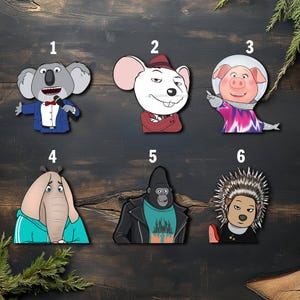 May include: Six cartoon character stickers labeled 1 through 6. 1 is a koala in a suit, 2 is a white mouse in a red suit, 3 is a pig in a space helmet, 4 is an elephant in a teal hoodie, 5 is a gorilla in a leather jacket, and 6 is a porcupine.