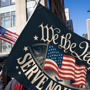 May include: A dark blue flag with the text "We the People" in a decorative font, along with an American flag graphic. The flag is held up in a city setting, with another American flag in the background.