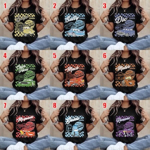 May include: Black short-sleeved t-shirts with various Cars movie character designs. Each shirt features a character's name, the year 2006, and the Rusteze logo. The designs include Lightning McQueen, Mater, and Doc Hudson.