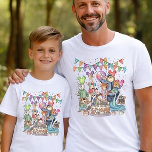 May include: White t-shirts with a colorful cartoon design featuring various animal characters, a birthday cake, and the number 4. The shirts have a festive banner design at the top and the word "Name" on the cake.