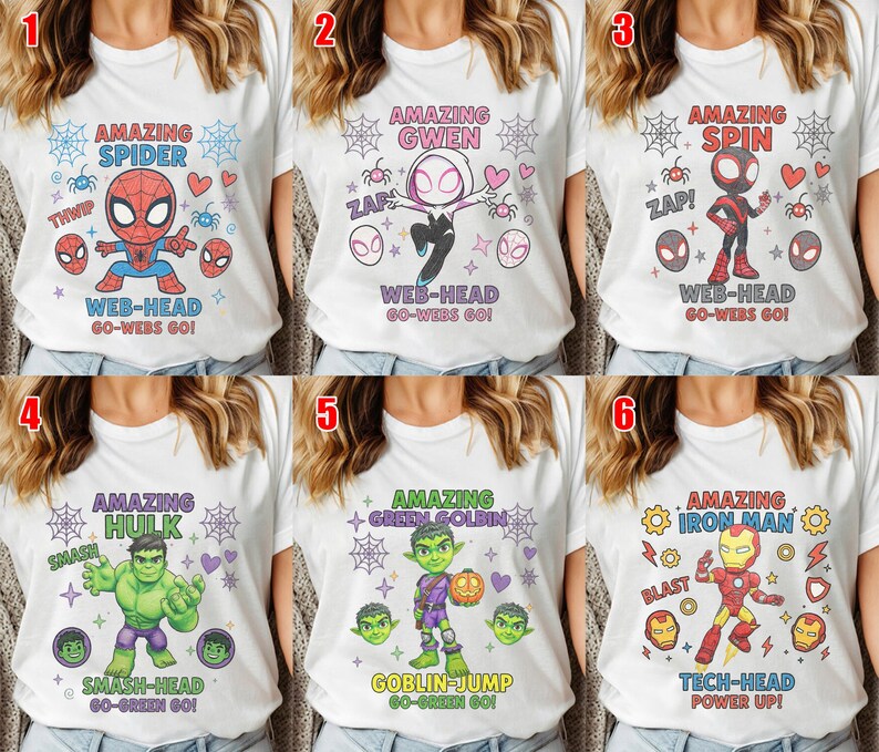 May include: White t-shirts featuring superhero designs. The shirts display characters such as Spider-Man, Gwen, Spin, Hulk, Green Goblin, and Iron Man. Each design includes character names and action phrases.