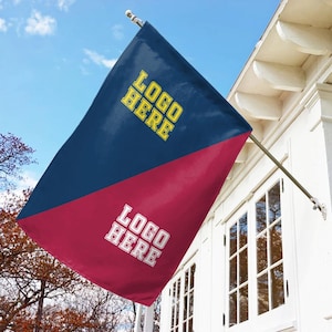May include: A diagonal split flag featuring a dark blue upper section with yellow text reading "LOGO HERE" and a maroon lower section with white text reading "LOGO HERE". The flag is mounted on a silver pole attached to a white building exterior.