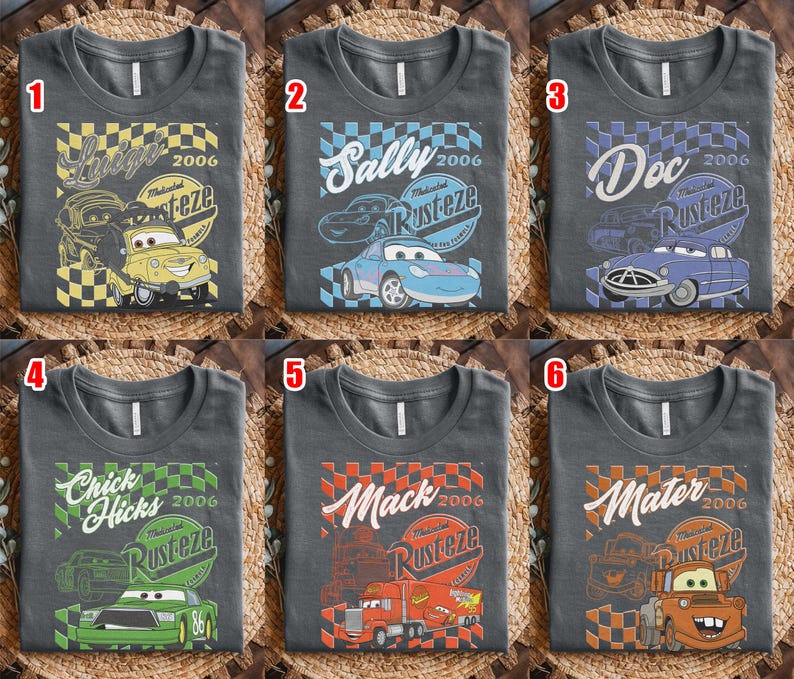 May include: Six charcoal gray t-shirts with different designs featuring characters from the movie Cars. Each shirt has a character's name, the year 2006, and the word "Rusteze". The characters include Luigi, Sally, Doc, Chick Hicks, Mack, and Mater.