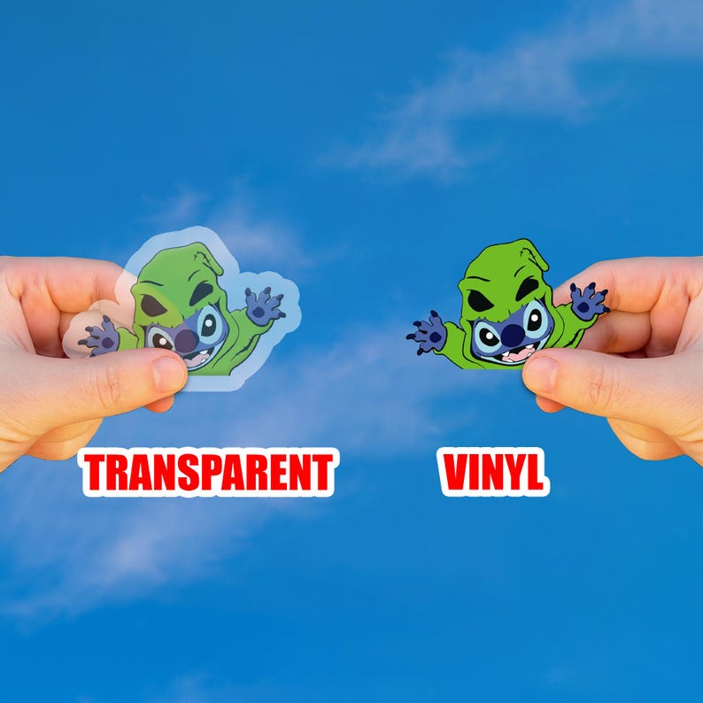 May include: Two stickers featuring a green cartoon character with blue accents, held against a blue sky. One sticker is transparent, the other is vinyl. The word "TRANSPARENT" is in red text below the transparent sticker, and "VINYL" is below the other.