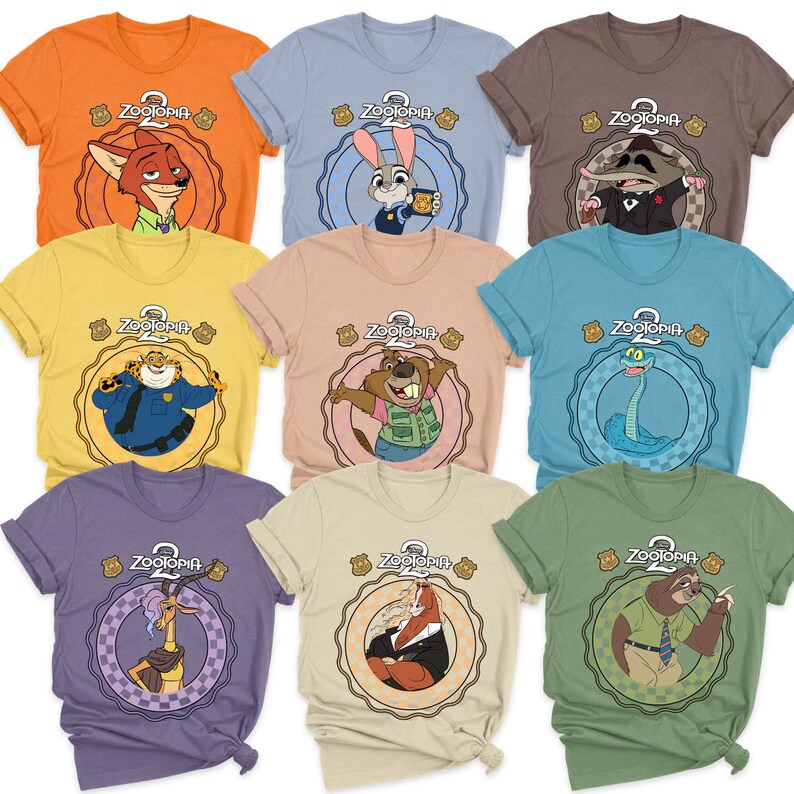 May include: A collection of colorful t-shirts featuring characters from the animated movie "Zootopia 2". Each shirt displays a different character within a circular design, with the movie's logo at the top. The shirts are in various colors, including orange, blue, and green.