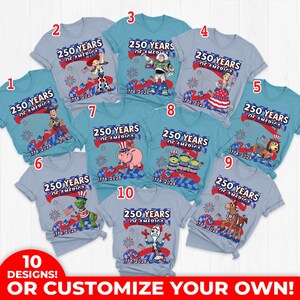 May include: A collection of ten light blue and gray t-shirts, each featuring a unique design celebrating 250 years of America. Designs include cartoon characters and patriotic themes, with the years 1776-2026 displayed. The text "OR CUSTOMIZE YOUR OWN!" is also visible.