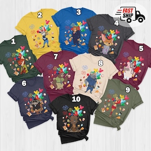 Puede incluir: Una colecci&oacute;n de diez camisetas coloridas, cada una con un personaje de dibujos animados, globos, fuegos artificiales y gr&aacute;ficos de comida. Las camisetas son de varios colores, incluyendo verde, amarillo, azul, gris, burdeos y negro. La imagen tambi&eacute;n incluye un logo "FAST SHIP".