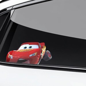 May include: A red Lightning McQueen car sticker with the word "Rust-eze" on the hood. The sticker is a cartoon image of the character from the movie Cars. The car is positioned as if it is driving.