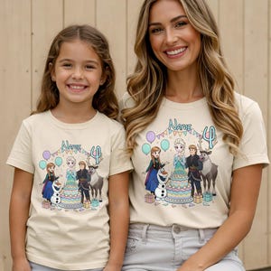 May include: Two beige t-shirts with a colourful graphic featuring characters from the movie Frozen, a birthday cake, and the number 4. The shirts are worn by a mother and daughter.
