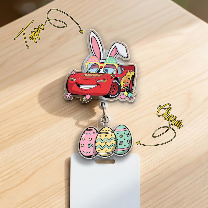 May include: A red car-shaped badge reel topper with bunny ears and sunglasses, paired with a charm of three decorated Easter eggs. The topper and charm are connected to a white badge holder. The word "Topper" and "Charm" are written in cursive.
