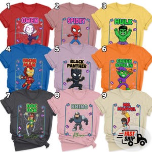 May include: A collection of nine brightly coloured t-shirts, each showcasing a different Marvel character. The designs feature characters like Gwen, Spidey, Hulk, Iron Man, Black Panther, Green Goblin, Doc Ock, Rhino, and Ms. Marvel, within a spiderweb frame.