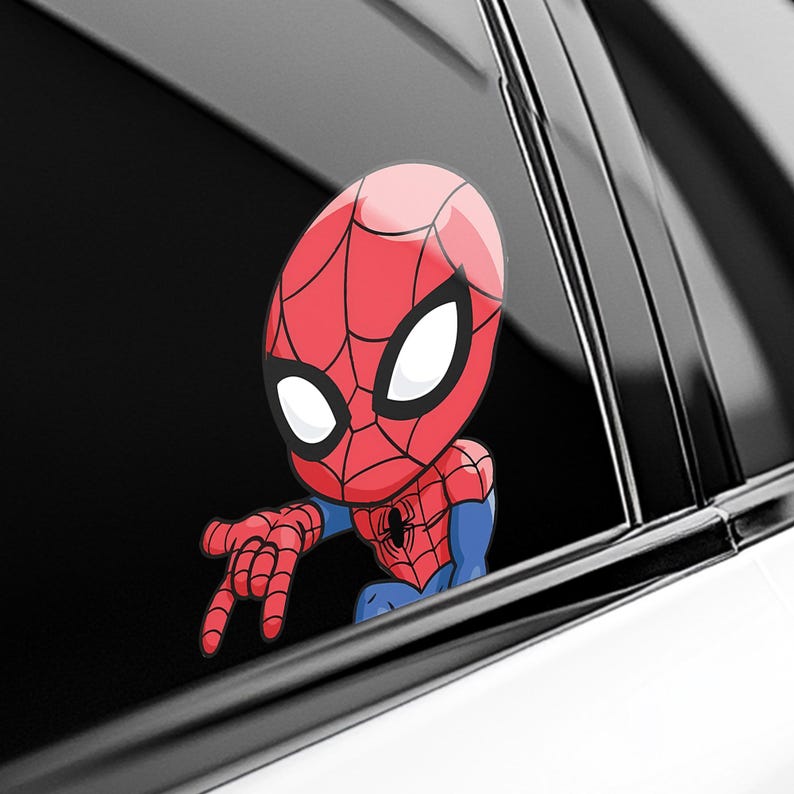 May include: A red and blue Spider-Man sticker, featuring a cartoon version of the superhero. The sticker is positioned as if it's peeking out from a car window, with the character's hand extended.