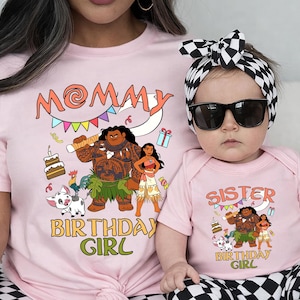 May include: A light pink t-shirt and a matching baby bodysuit, both featuring a graphic print of Moana characters, a cake, and the text MOMMY BIRTHDAY GIRL and SISTER BIRTHDAY GIRL. The baby wears a black and white checkered headband and sunglasses.