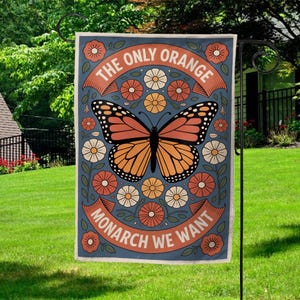 May include: A garden flag with a monarch butterfly design. The flag features a blue background with a large orange and black butterfly in the center, surrounded by flowers. Text reads "THE ONLY ORANGE MONARCH WE WANT".