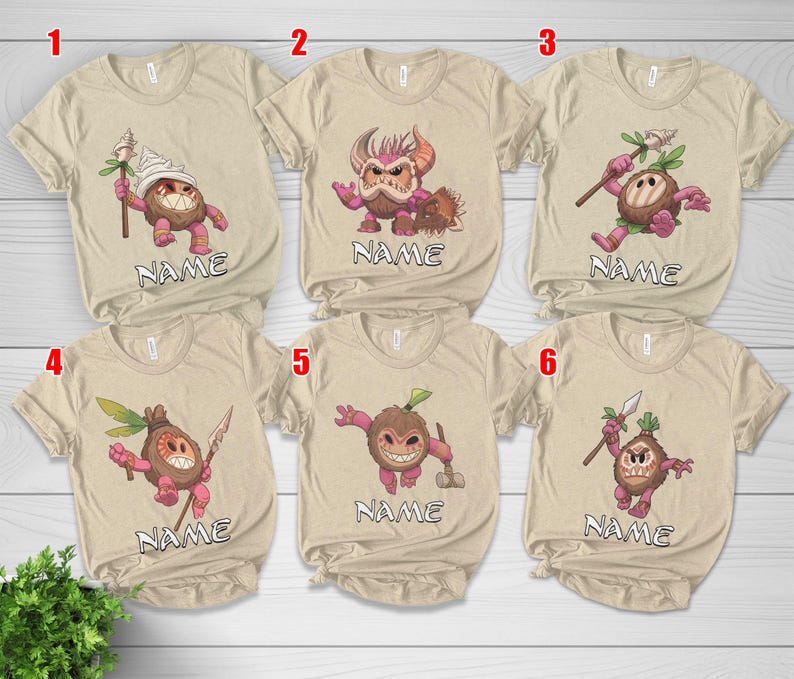 Puede incluir: Seis camisetas beige con gr&aacute;ficos de monstruos de dibujos animados. Cada camiseta presenta un dise&ntilde;o de monstruo diferente en tonos de marr&oacute;n, rosa y verde. La palabra "NAME" est&aacute; impresa debajo de cada personaje. Las camisetas son de manga corta y tienen cuello redondo.