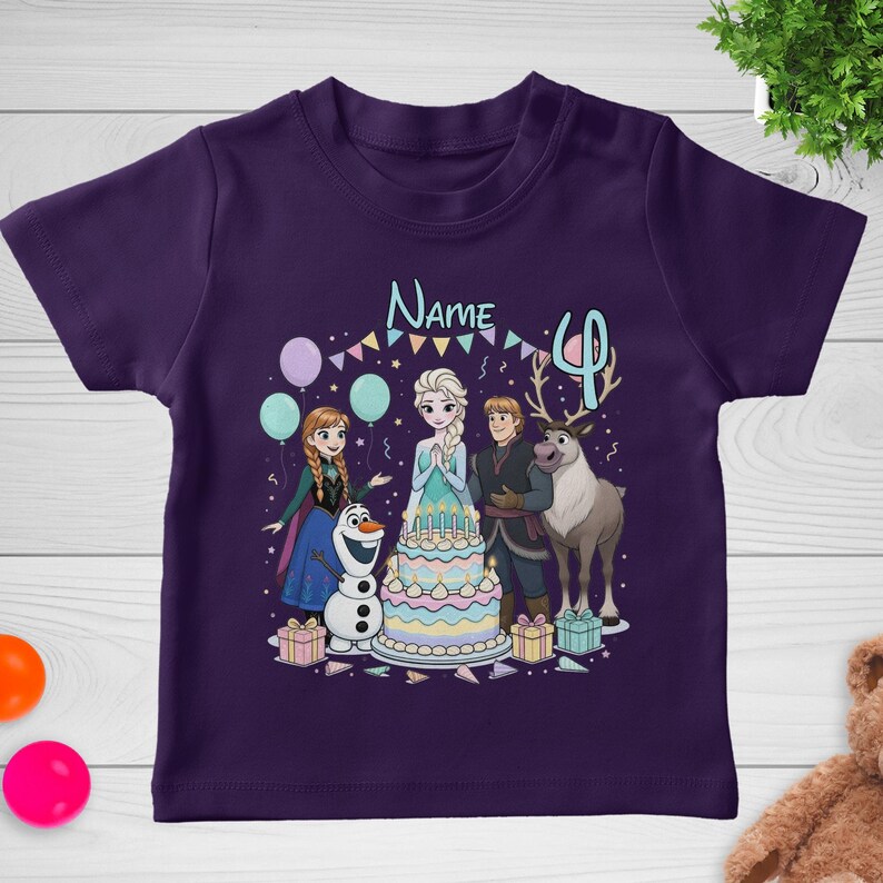 May include: A purple t-shirt featuring a colorful graphic of characters from the movie Frozen, including Elsa, Anna, Olaf, Kristoff, and Sven. The design includes a birthday cake, balloons, and the number 4.