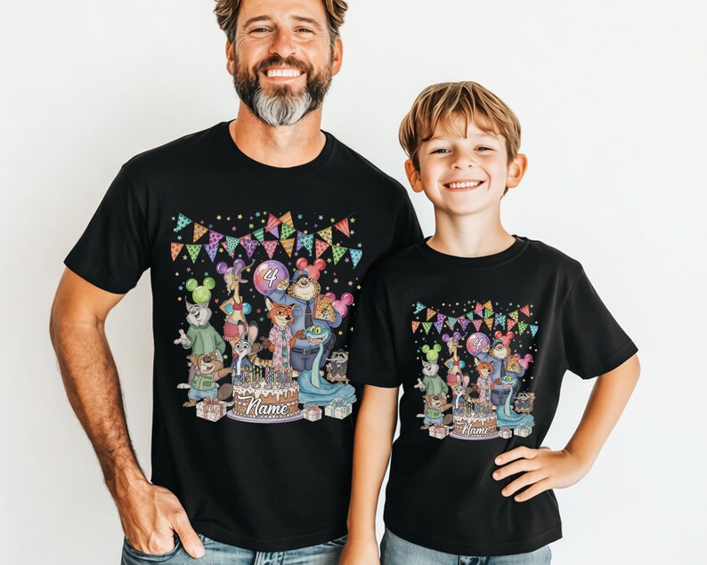 May include: Black t-shirts with a colorful birthday graphic. The graphic features cartoon animals, a cake, balloons, and the number 4. The shirts are worn by a man and a child.