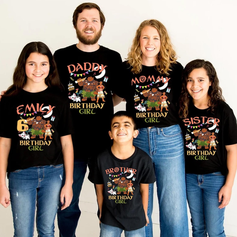 May include: A set of five black t-shirts featuring a Moana-themed graphic with characters, a birthday cake, and colorful bunting. Each shirt displays specific text: Emily, Daddy, Mommy, Brother, and Sister, all with the words Birthday Girl.